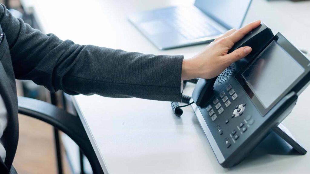man reaching for handset