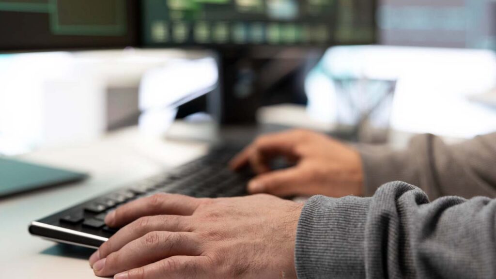 hands typing on keyboard
